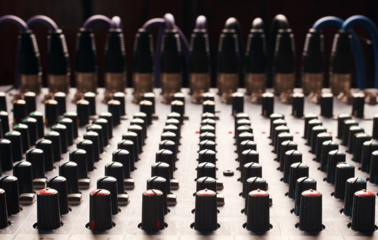A multi-channel audio mixing board with many knobs and inputs, illustrating how the stacking method can be made very complex by adding different models, learning algorithms, hyperparameters, and sets of features